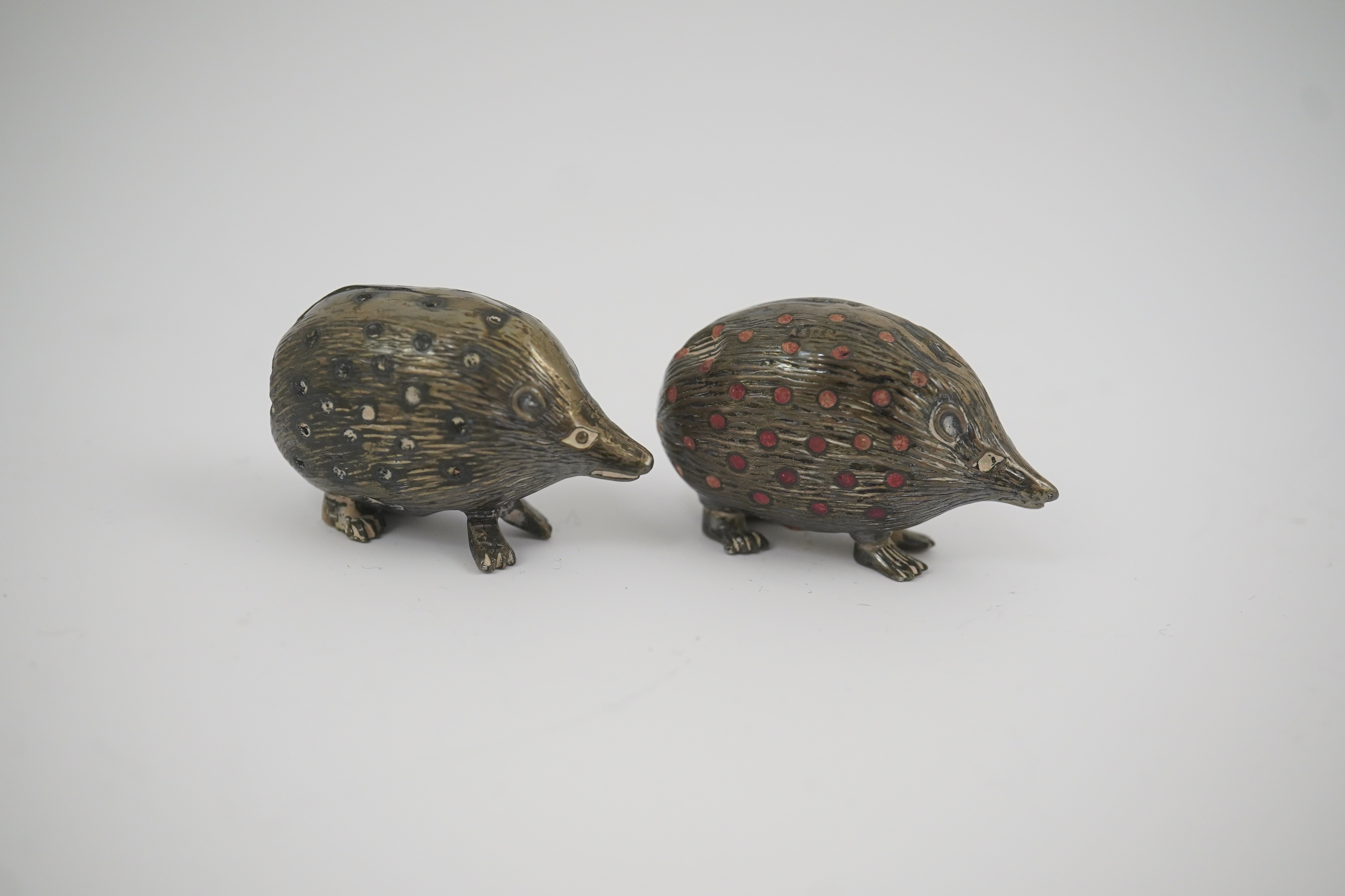 Two Edwardian silver novelty pin cushions, modelled as porcupines